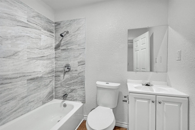 full bathroom featuring vanity, toilet, and tiled shower / bath combo