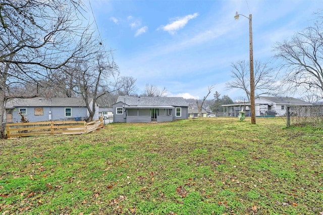 rear view of property with a yard