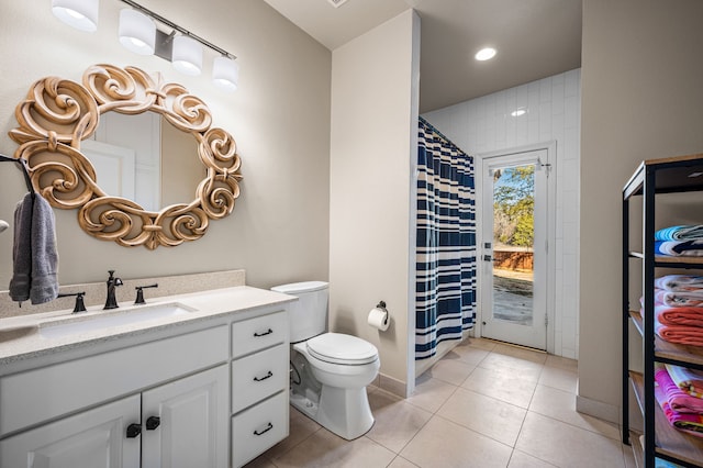 bathroom featuring vanity, tile patterned floors, and toilet