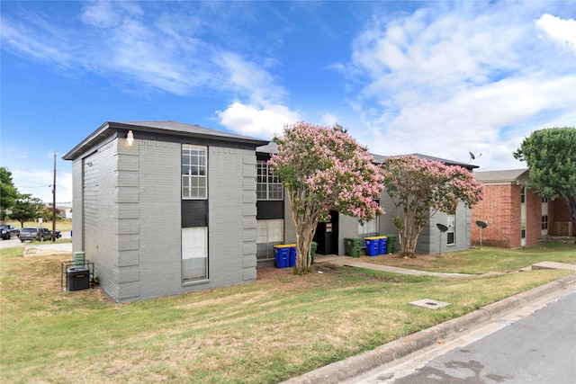 exterior space with a yard and central air condition unit