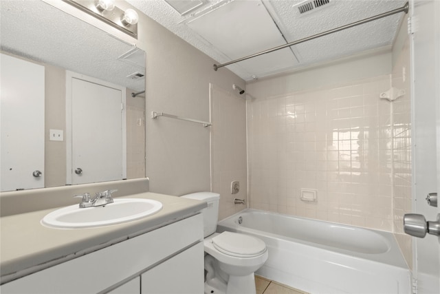 full bathroom with vanity, tile patterned floors, toilet, and tiled shower / bath