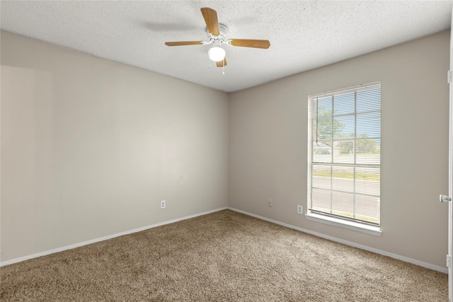 carpeted spare room with ceiling fan and a textured ceiling