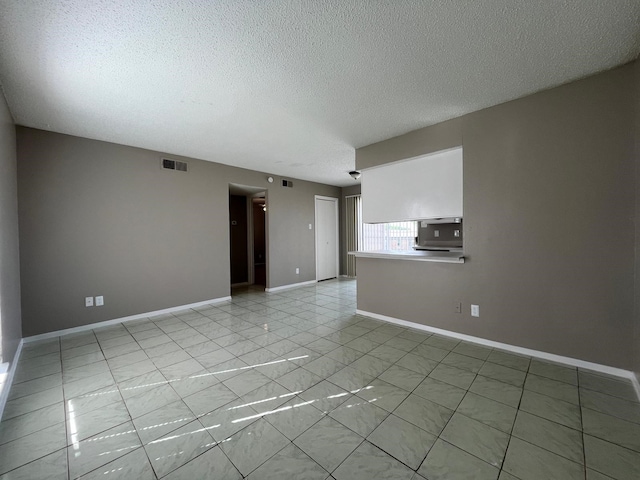 empty room with a textured ceiling