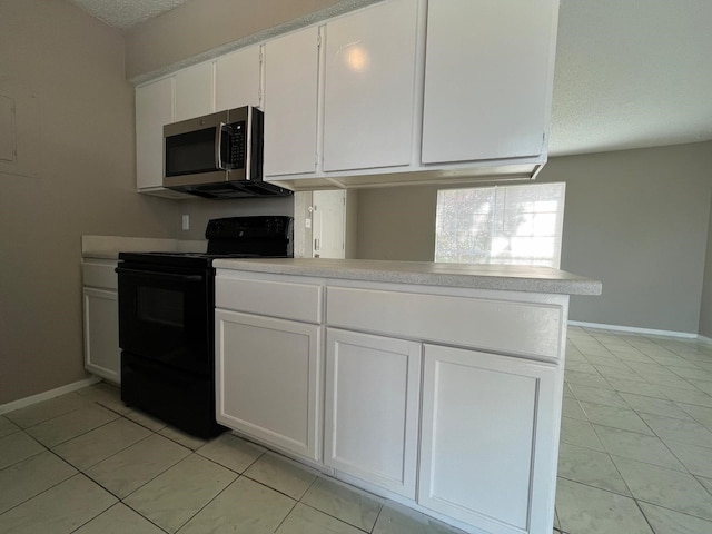 kitchen with kitchen peninsula, black electric range, a textured ceiling, and white cabinets