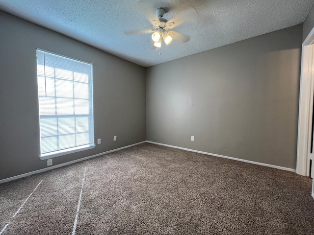 spare room with ceiling fan, carpet, and a textured ceiling