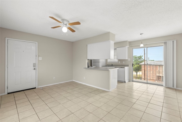 unfurnished living room with ceiling fan, a textured ceiling, and light tile patterned floors