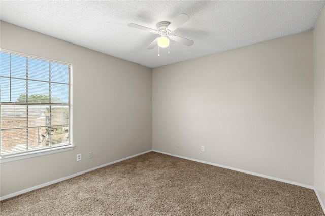 unfurnished room with a textured ceiling, ceiling fan, and carpet flooring