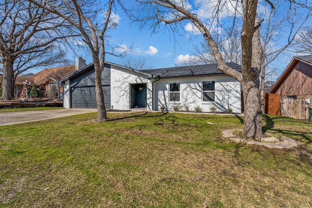 view of front of home featuring a garage and a front lawn