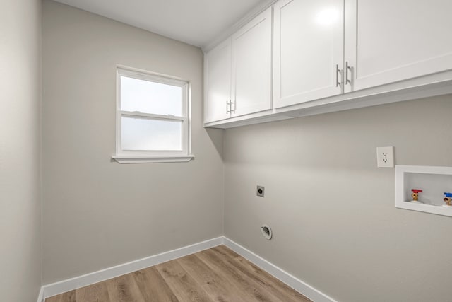 clothes washing area featuring cabinets, washer hookup, hookup for an electric dryer, and light hardwood / wood-style floors