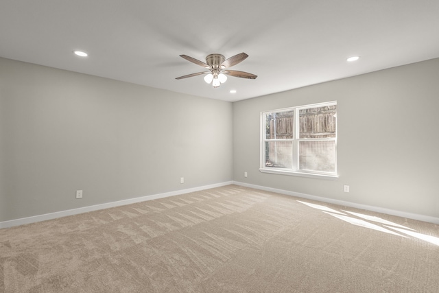 unfurnished room with ceiling fan and light colored carpet