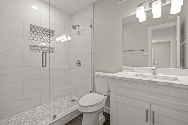 bathroom with vanity, an enclosed shower, and toilet