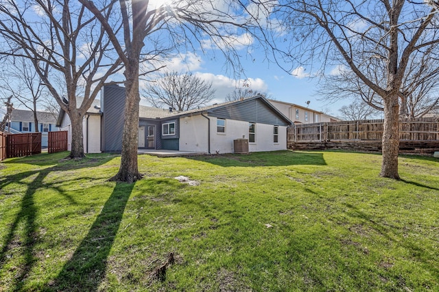 view of home's exterior featuring central AC unit and a yard