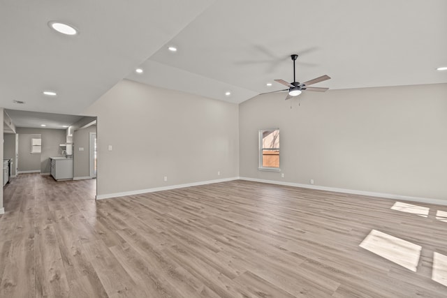 unfurnished living room featuring lofted ceiling, ceiling fan, and light hardwood / wood-style flooring