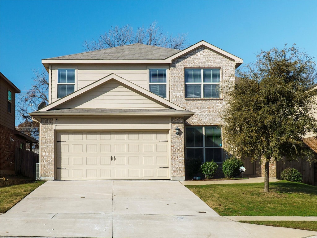 view of front of property featuring a garage and a front lawn