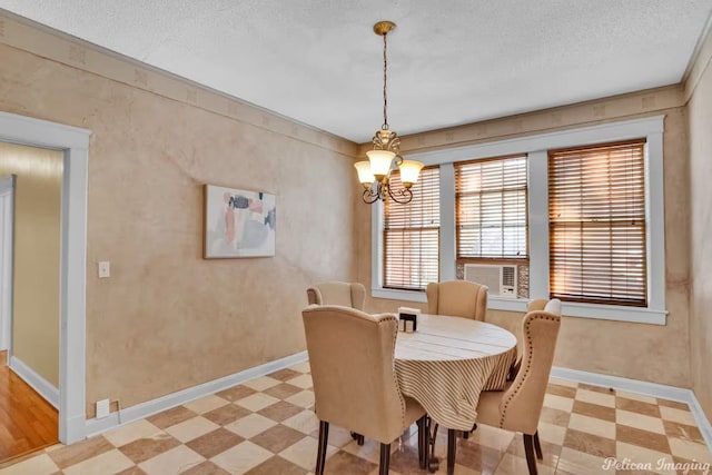 dining room with a chandelier and a textured ceiling