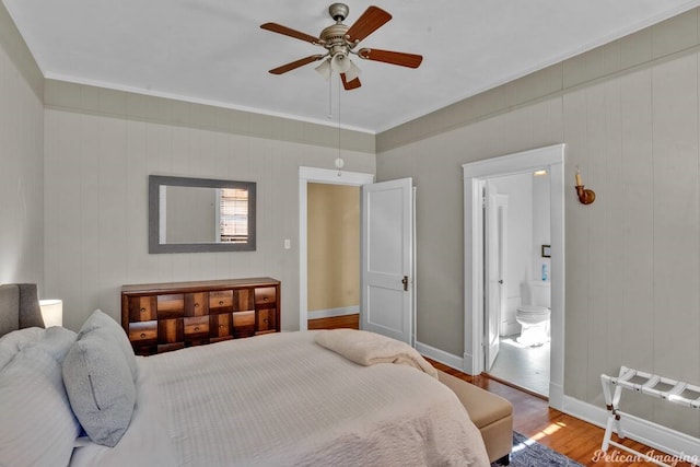 bedroom with hardwood / wood-style flooring, ensuite bath, and ceiling fan