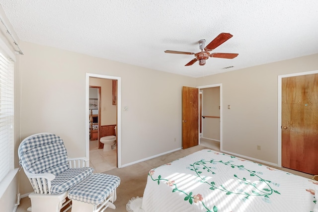 bedroom featuring a textured ceiling, light carpet, and visible vents