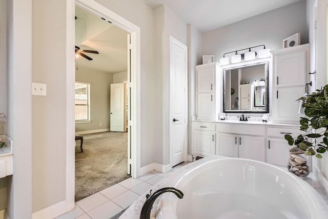 bathroom featuring tile patterned flooring, vanity, a washtub, and ceiling fan