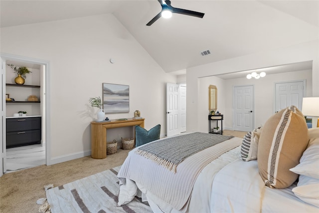 carpeted bedroom with ceiling fan, ensuite bathroom, and high vaulted ceiling