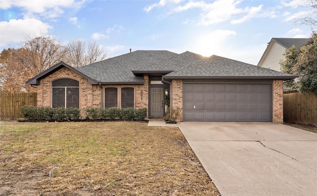 single story home featuring a garage and a front lawn