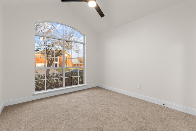 carpeted empty room with ceiling fan and vaulted ceiling