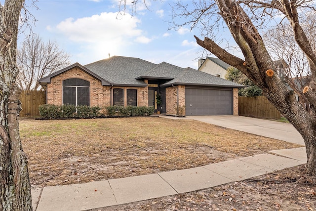 view of front of house featuring a garage and a front lawn