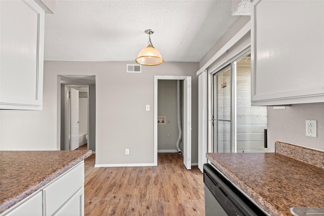 kitchen featuring pendant lighting, white cabinetry, dishwasher, a textured ceiling, and light hardwood / wood-style flooring