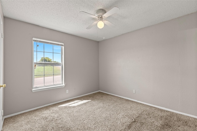 carpeted empty room with ceiling fan and a textured ceiling