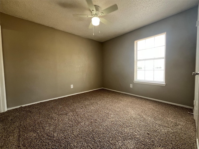 carpeted empty room featuring ceiling fan and a textured ceiling