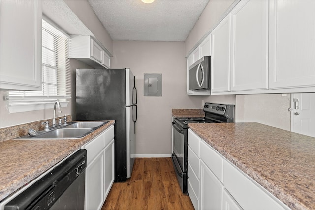 kitchen with appliances with stainless steel finishes, sink, and white cabinets