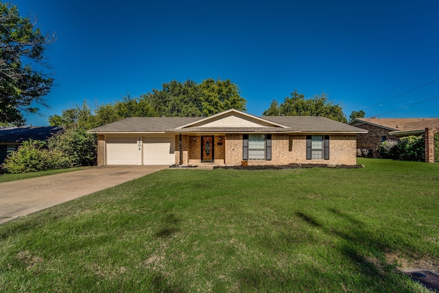 ranch-style home featuring a garage and a front lawn