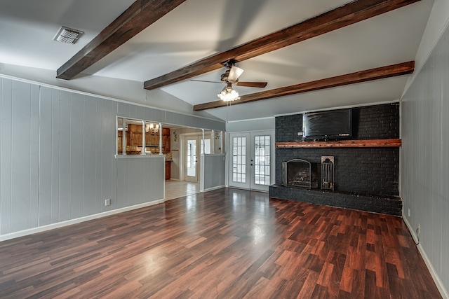 unfurnished living room featuring a brick fireplace, dark hardwood / wood-style floors, vaulted ceiling with beams, and ceiling fan