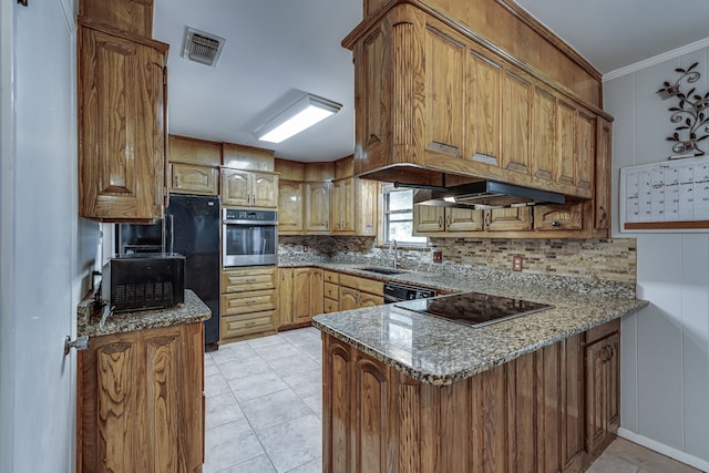 kitchen with stone counters, sink, kitchen peninsula, and black appliances