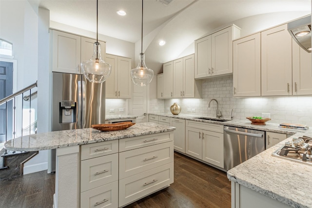 kitchen featuring white cabinetry, appliances with stainless steel finishes, dark wood-type flooring, and hanging light fixtures