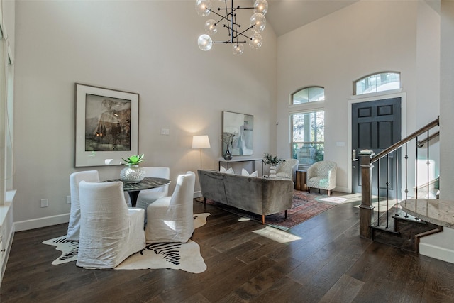 dining space featuring dark hardwood / wood-style floors, a chandelier, and high vaulted ceiling