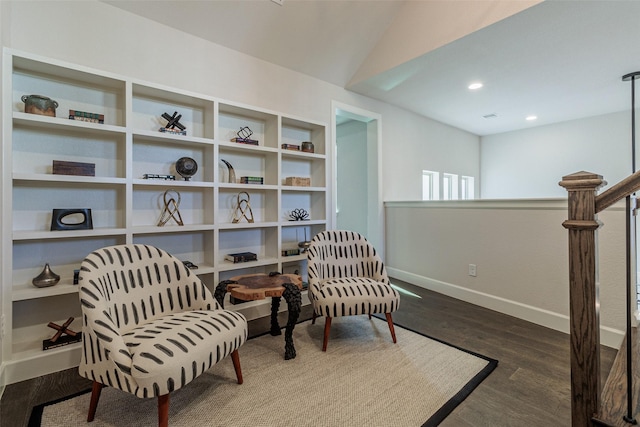 sitting room featuring wood-type flooring and vaulted ceiling