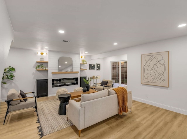 living room featuring a fireplace and light hardwood / wood-style floors