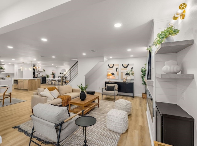 living room featuring a fireplace and light hardwood / wood-style flooring