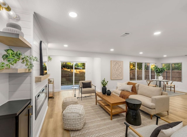 living room with a fireplace and light hardwood / wood-style flooring