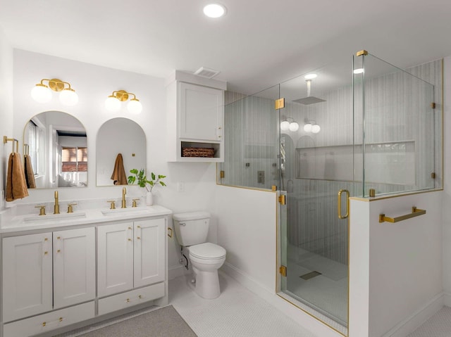 bathroom with tile patterned flooring, vanity, an enclosed shower, and toilet