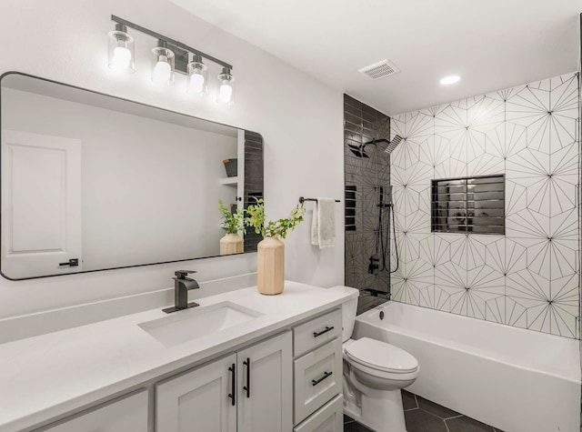 full bathroom featuring tiled shower / bath combo, vanity, tile patterned flooring, and toilet