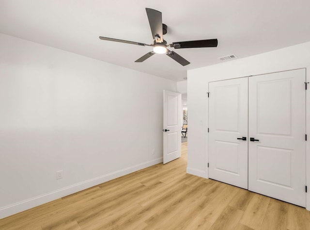 unfurnished bedroom with ceiling fan, light hardwood / wood-style floors, and a closet