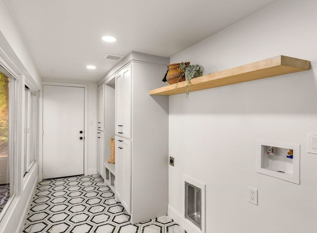 washroom with washer hookup, cabinets, and hookup for an electric dryer