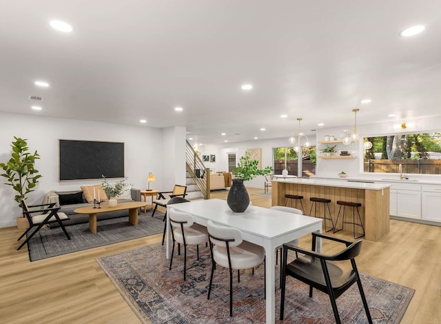 dining area featuring sink and light wood-type flooring