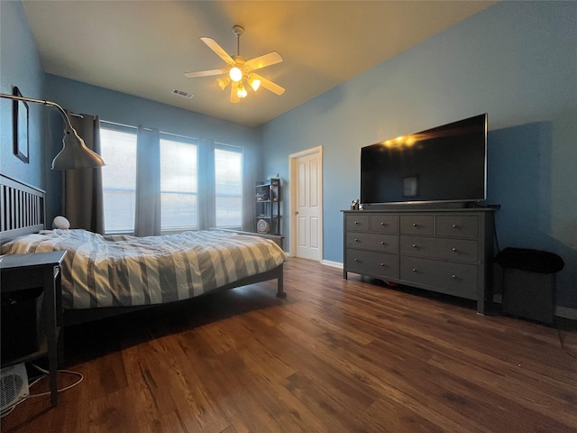 bedroom with dark wood-type flooring, ceiling fan, and vaulted ceiling