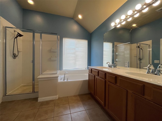 bathroom featuring tile patterned flooring, vanity, vaulted ceiling, and shower with separate bathtub