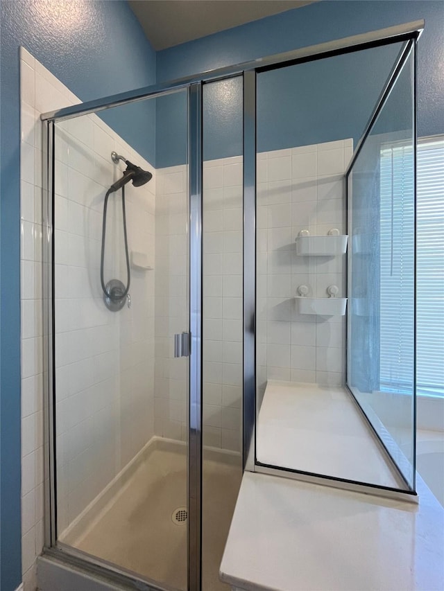 bathroom with a shower with door