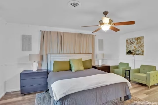 bedroom with ceiling fan and light hardwood / wood-style floors