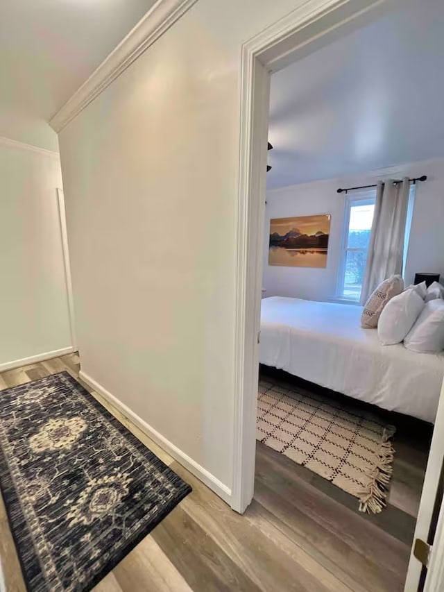 bedroom featuring hardwood / wood-style flooring and ornamental molding