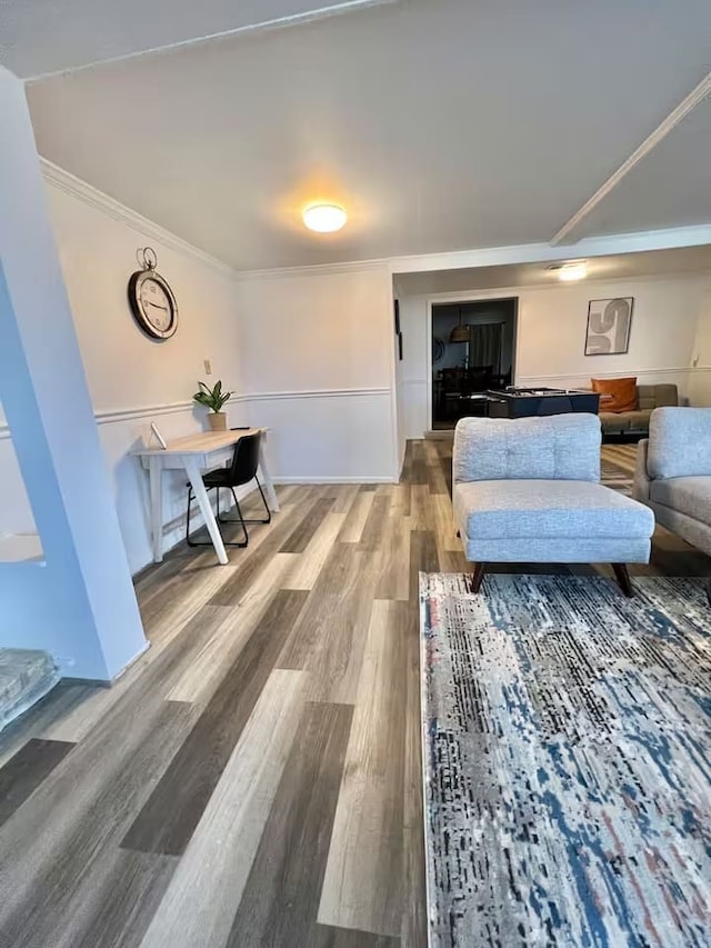 living room with ornamental molding and hardwood / wood-style floors